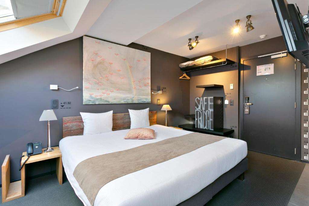 een slaapkamer met een groot wit bed in een kamer bij Boutique Hotel Saint-Géry in Brussel